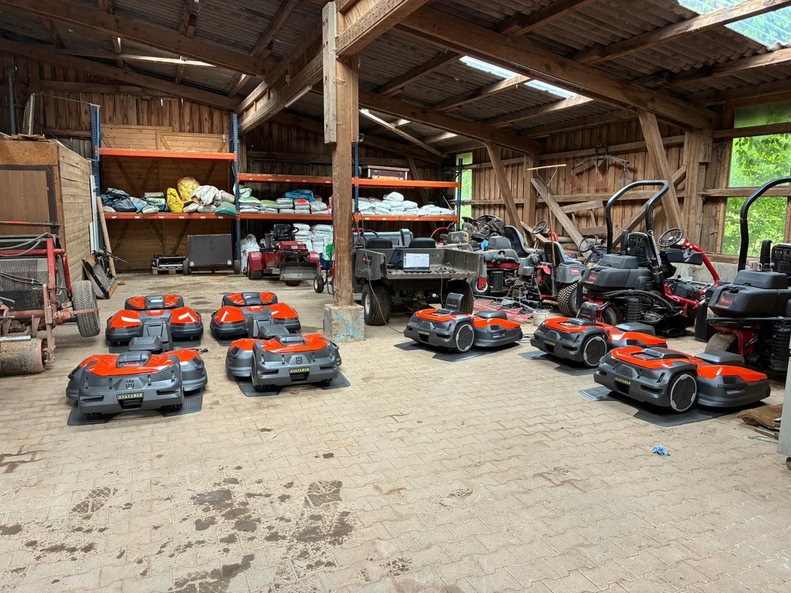 Professional robotic mower fleet storage and management facility